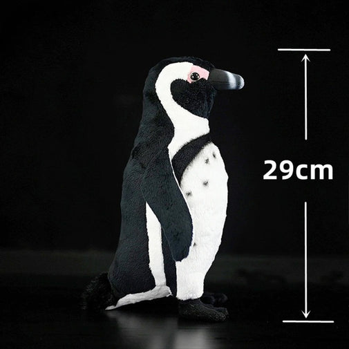 Plush penguin toy with dimensions on a black background