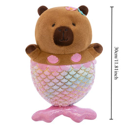 A capybara plush toy with a pink mermaid tail and shell accents, shown on a white background with a vertical height measurement marker reading 30cm/11.8 inches.