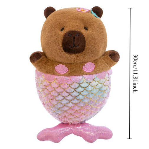 A capybara plush toy with a pink mermaid tail and shell accents, shown on a white background with a vertical height measurement marker reading 30cm/11.8 inches.