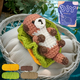 Crocheted animal toy with yarn and DIY crochet kit on a white surface