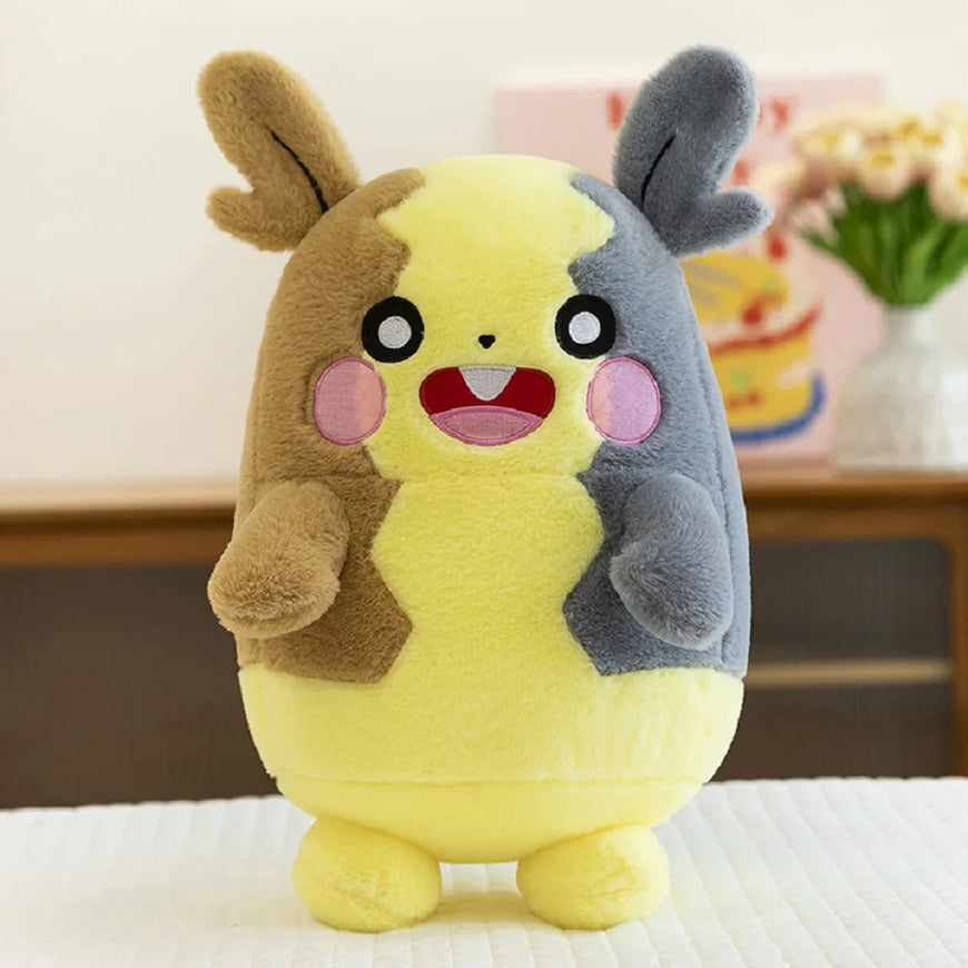 Plush toy with a yellow body, brown ears, and gray tail on a white surface.