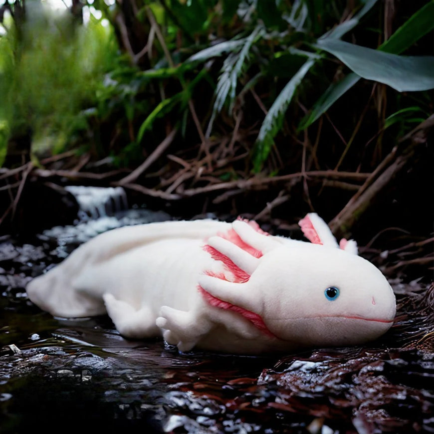 Plush axolotl toy on a natural background with plants