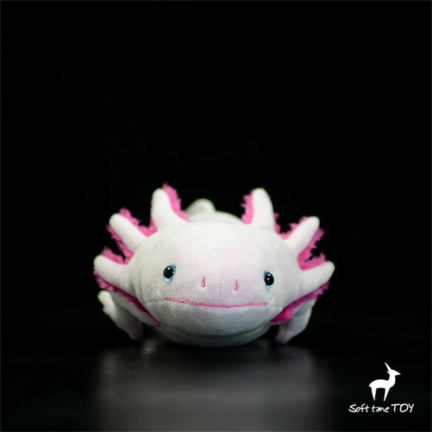 Plush toy axolotl with pink highlights on a black background