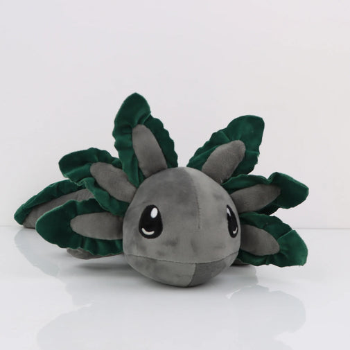 Plush toy with green leaf-like appendages on a white background
