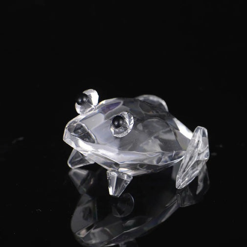 Crystal frog figurine on a black background