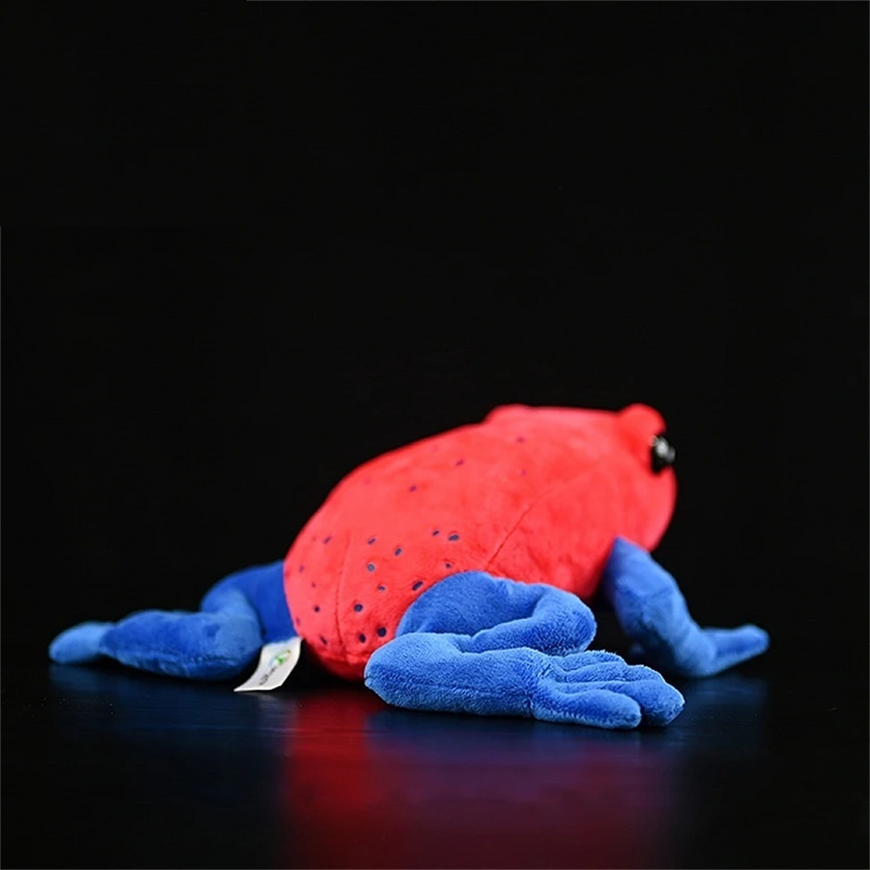 Red and blue plush toy on a black background