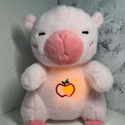 Plush toy with glowing chest featuring an apple design against a textured wall.