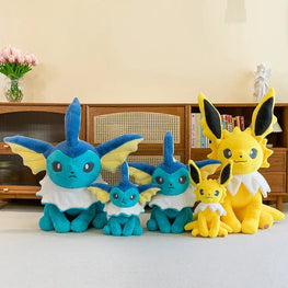 A set of five plush toy Eeveys in different sizes arranged in front of a wooden cabinet in a home interior setting.