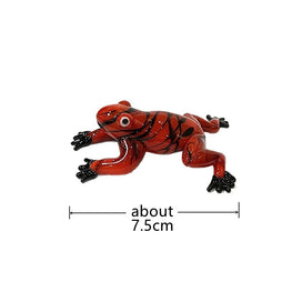 Red and black frog figurine with measurement label on a white background