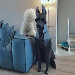Geometric dog sculpture in a living room with a white dog on a blue sofa.