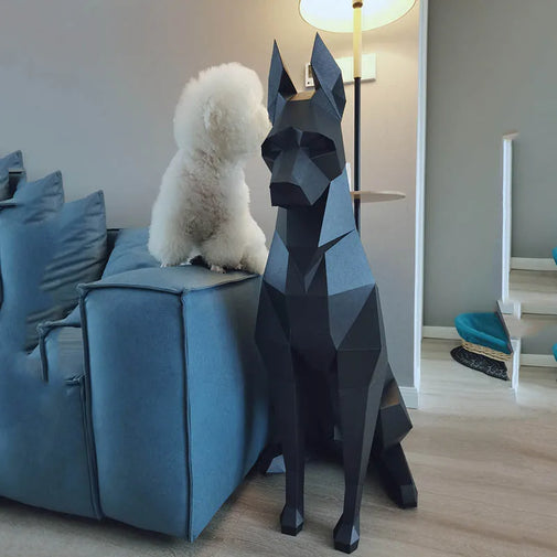 Geometric dog sculpture in a living room with a white dog on a blue sofa.