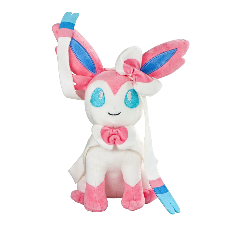 A plush toy of the character Eevee, featuring a soft white body, pink and blue ear accents, a pink bow on its head, and a pink bow around its neck, set against a plain white background.
