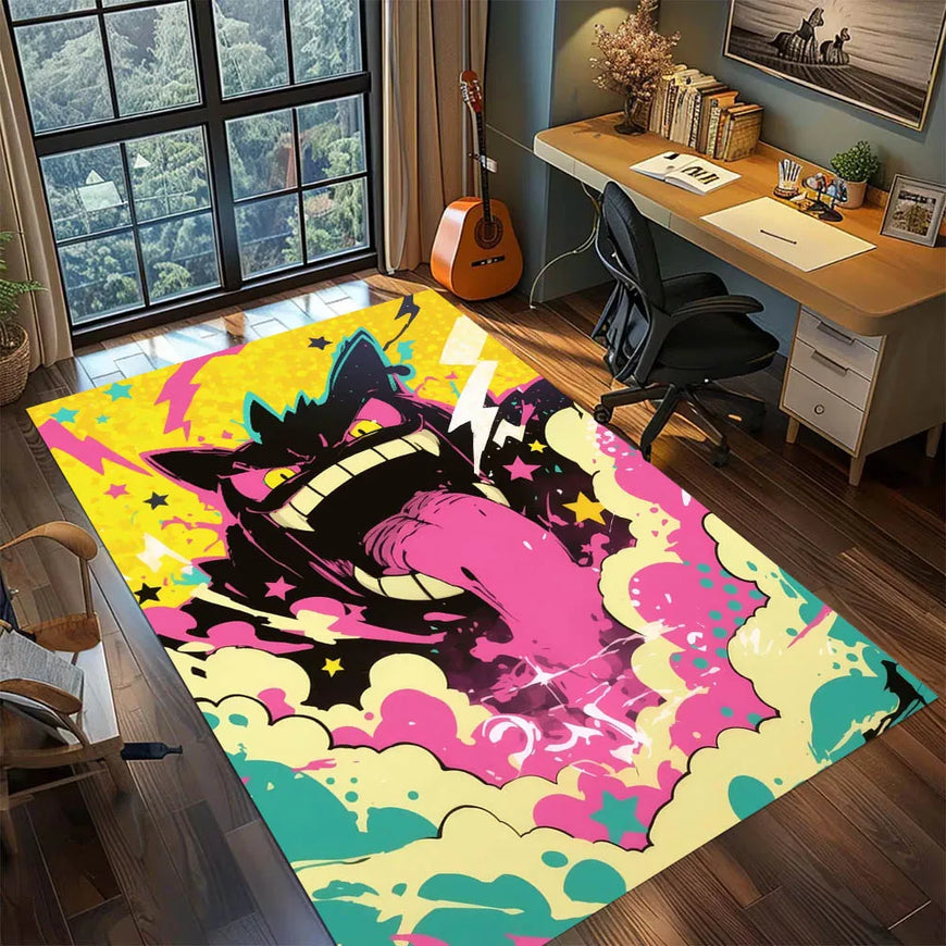 A large rectangular area rug with a bold anime-style chibi character print in pink, yellow, black, and teal, shown in a modern home office setting with a desk, chair, and window.