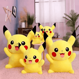 A set of five yellow Pikachu plush toys in different sizes arranged on a pink rug in a styled room with plants and a window.